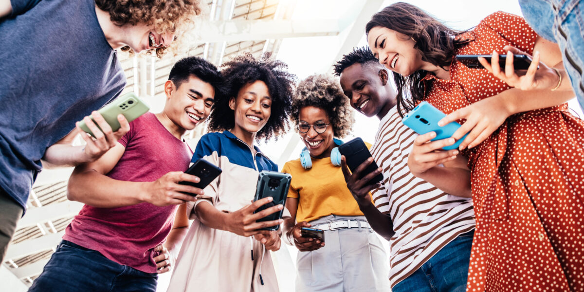 Numerous teenage students using smart phones