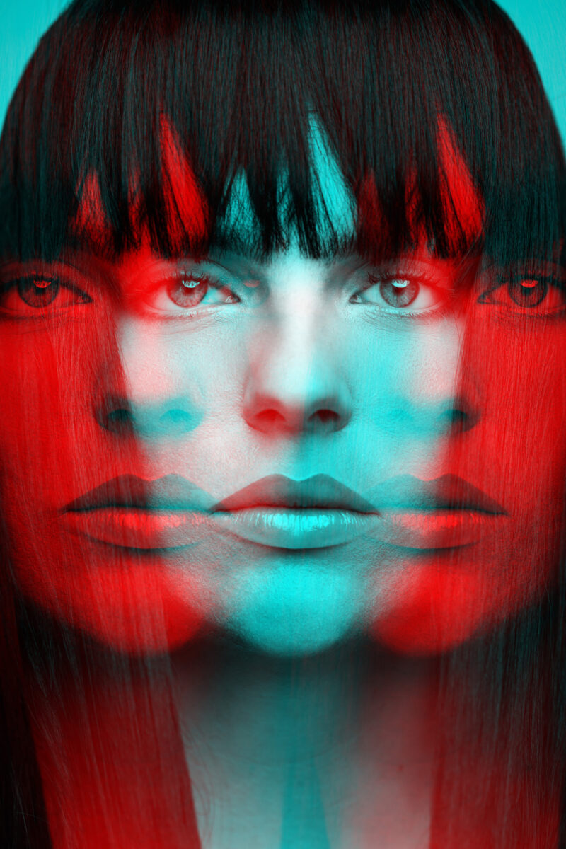 Woman with long dark hair close-up fashion portrait in RGB color split