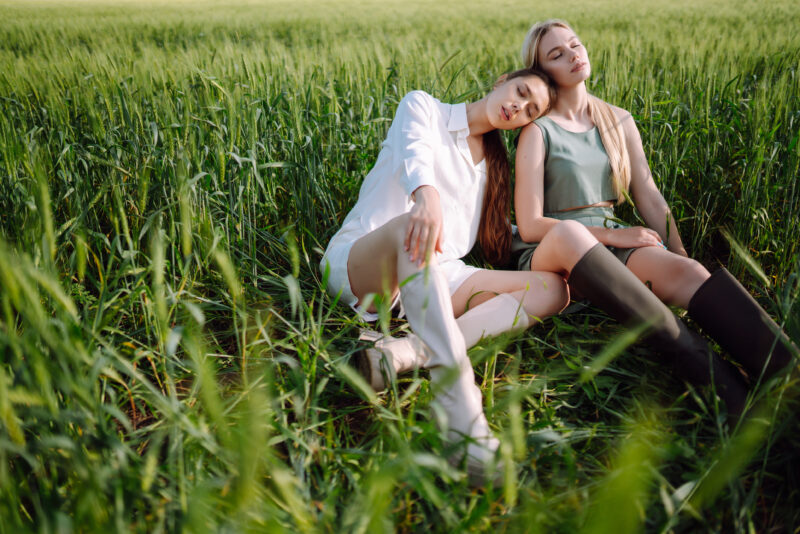 Two women in the green field. Freedom travel