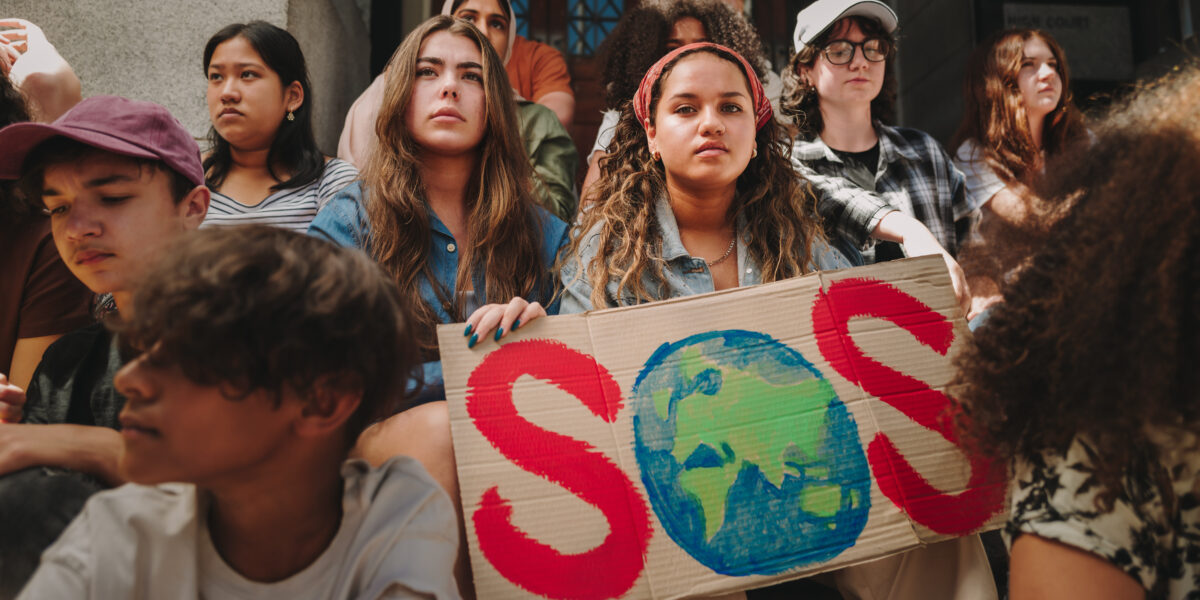 Youth demonstrators protesting against global warming and climate change outside a building
